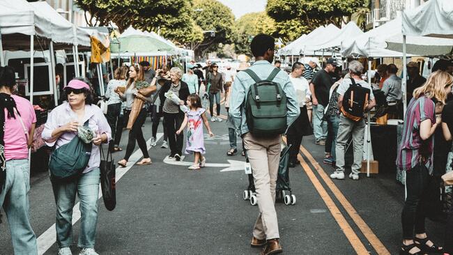 consumers walking among pop up tents